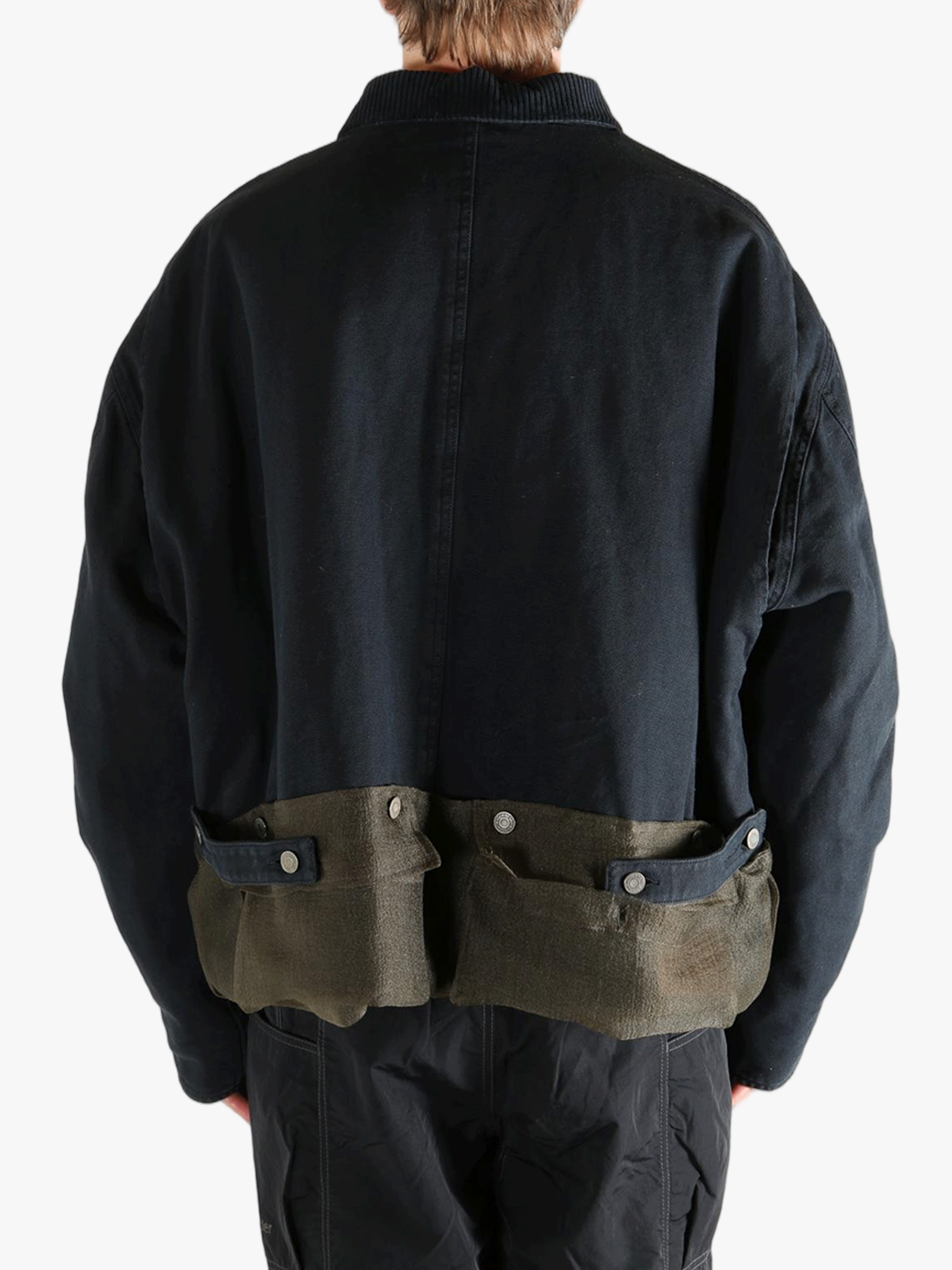 Black jacket worn by a person, showing the jacket's fit