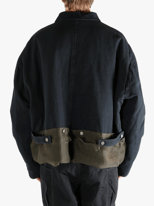Black jacket worn by a person, showing the jacket's fit