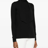 Black tops worn by a person, showing the tops' fit
