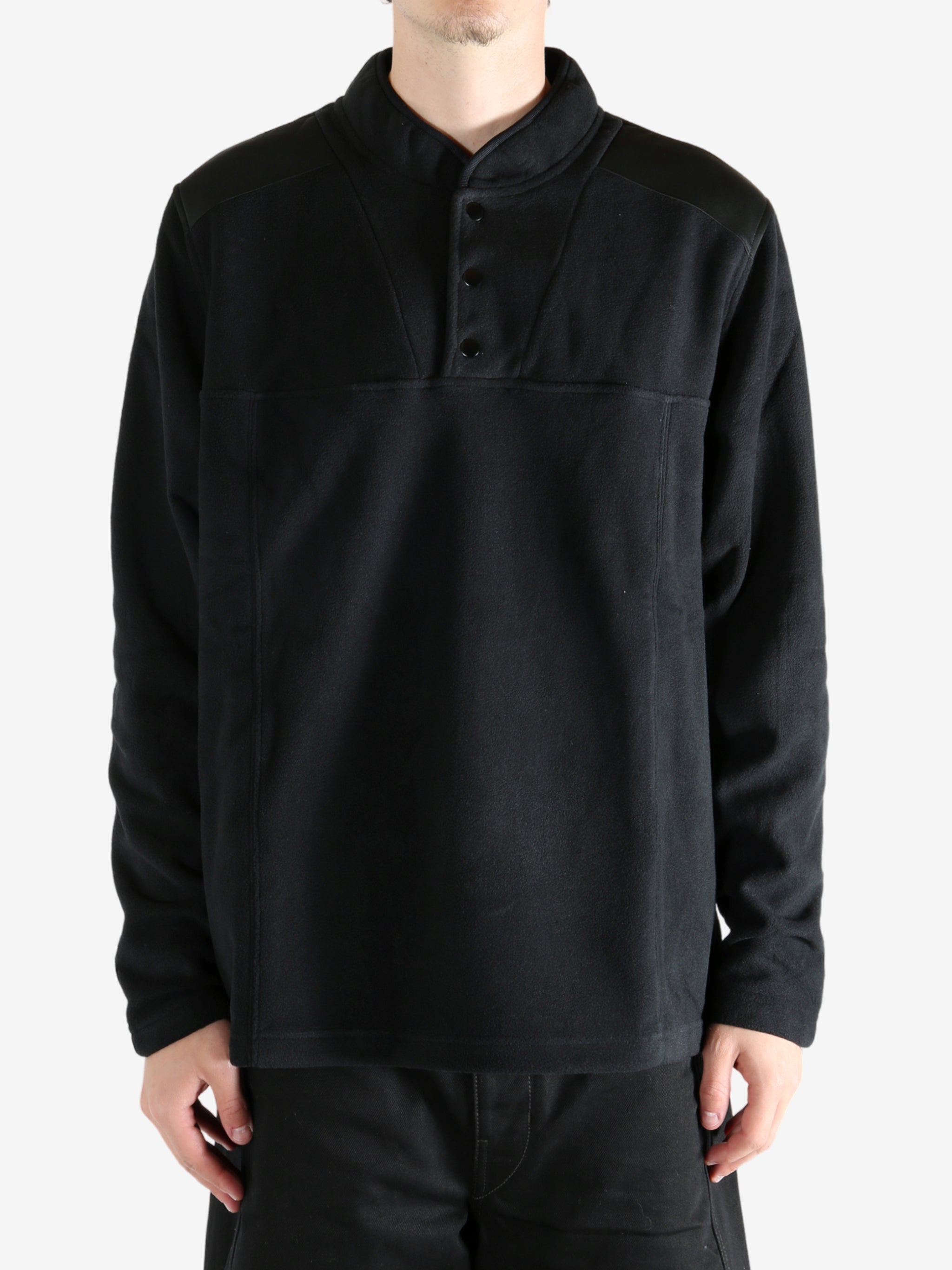 Black sweatshirt worn by a person, showing the sweatshirt's fit