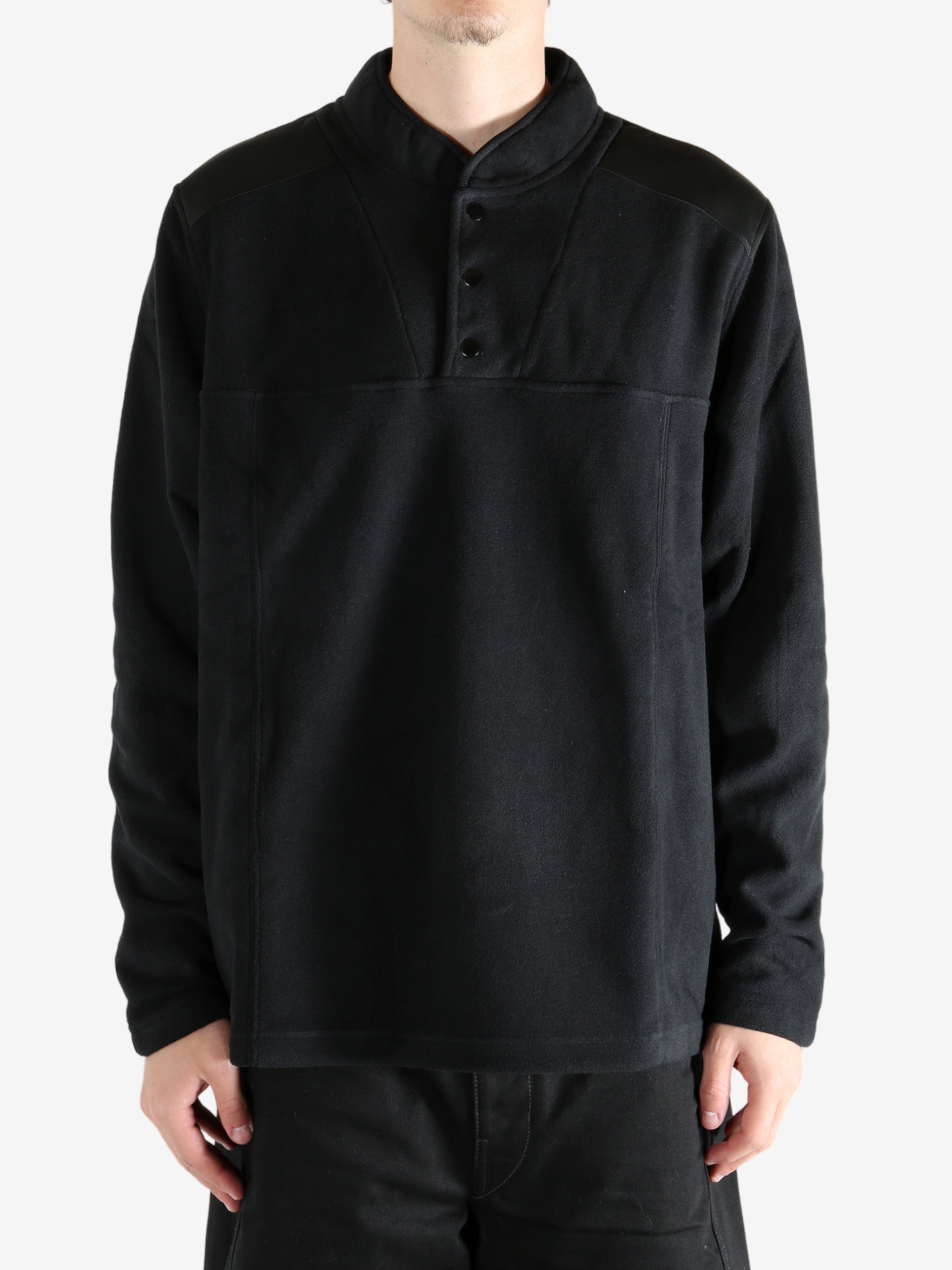 Black sweatshirt worn by a person, showing the sweatshirt's fit