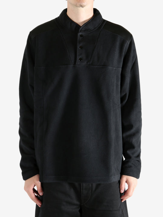Black sweatshirt worn by a person, showing the sweatshirt's fit