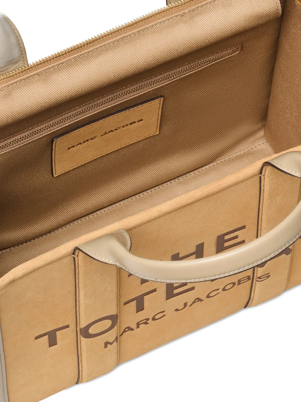 close up of brown bags, showing texture of the suede cow leather fabric