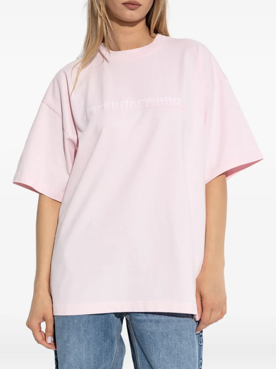 Pink t-shirt worn by a person, showing the shirt's fit