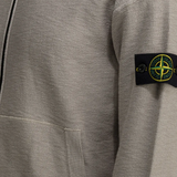 Gray sweatshirt with a brand logo on the sleeve