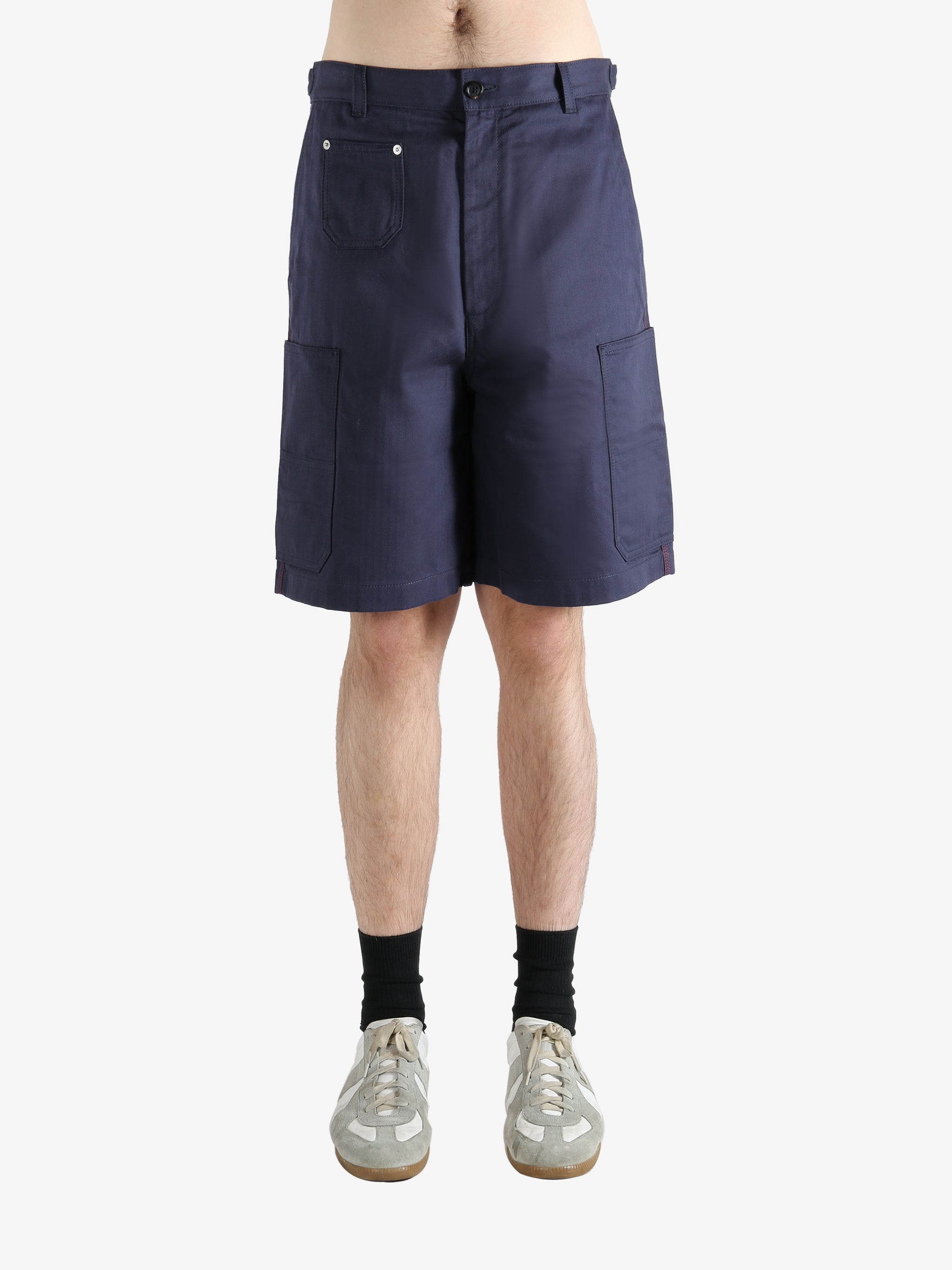 Navy shorts worn by a person, showing the shorts fit