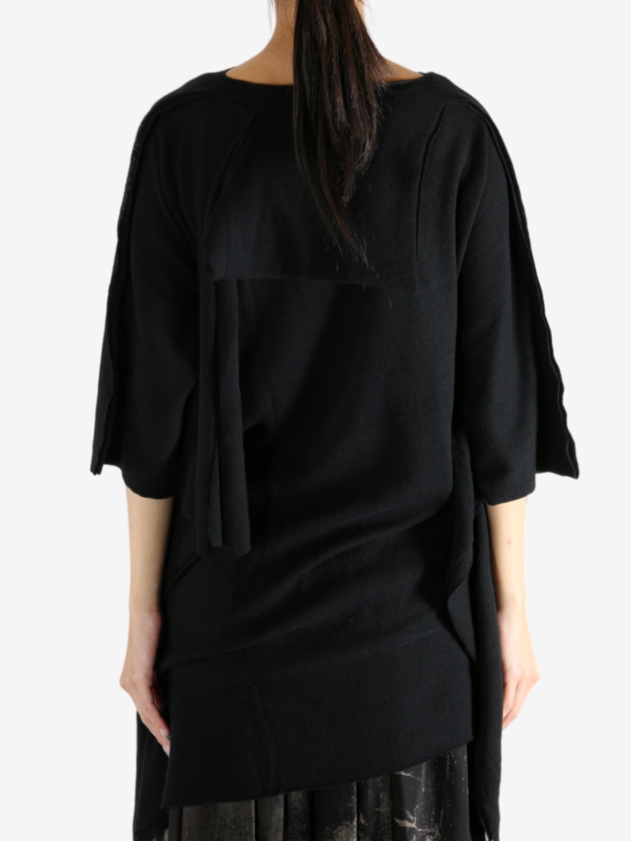 Black top worn by a person, showing the top's fit