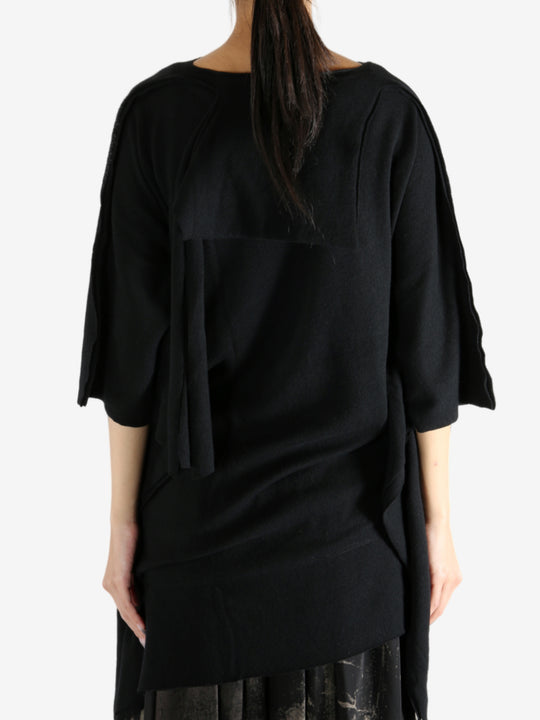 Black top worn by a person, showing the top's fit