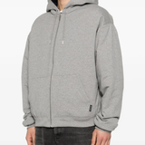 Grey hoodie worn by a person, showing the hoodie fit
