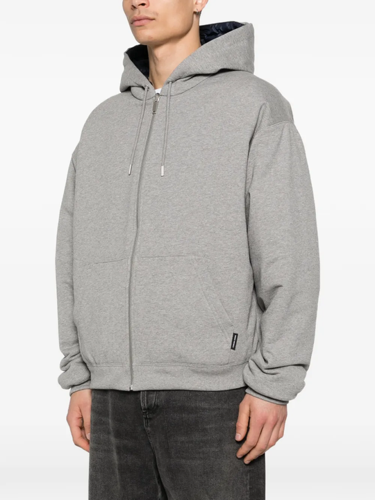 Grey hoodie worn by a person, showing the hoodie fit