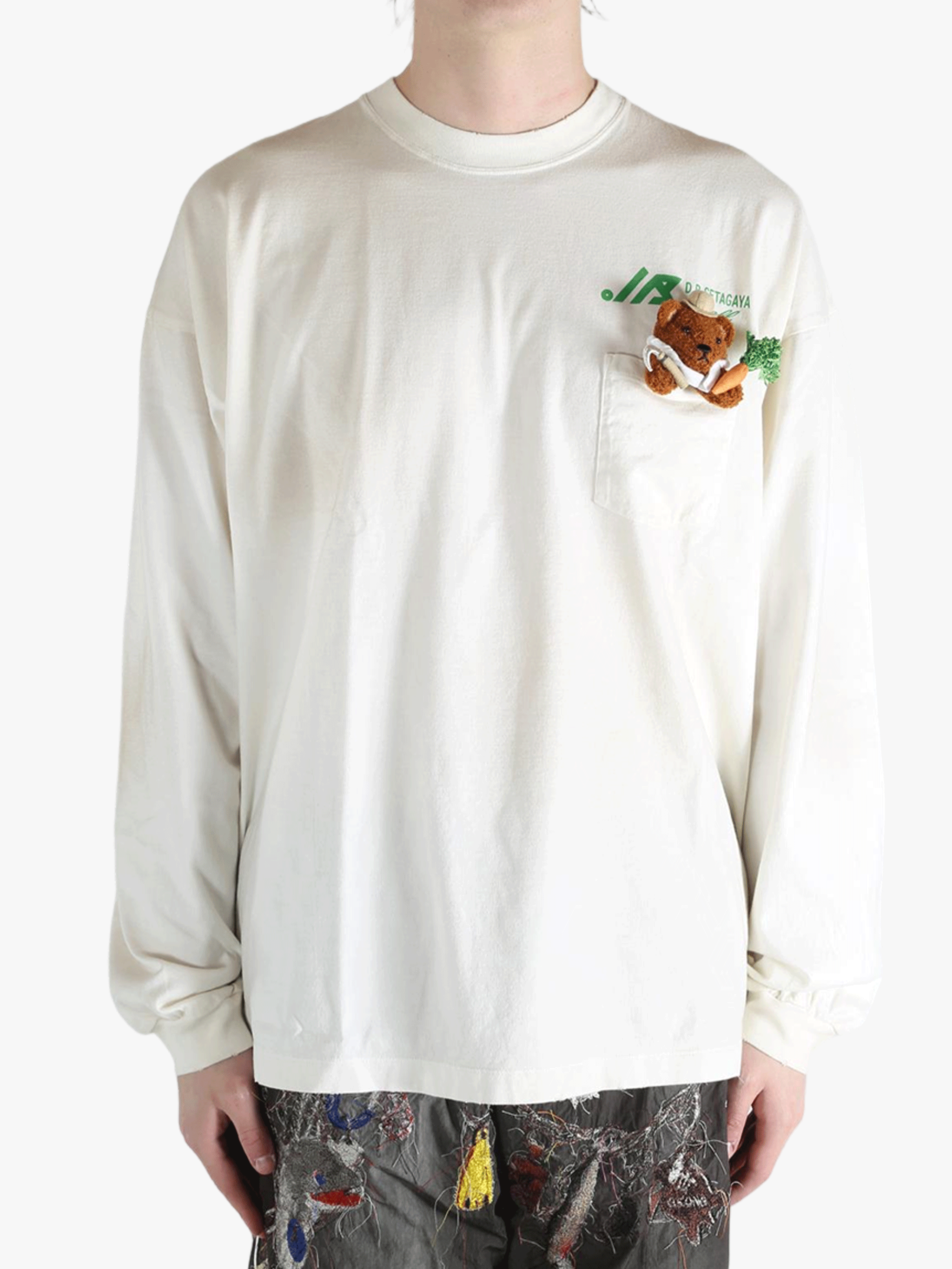 White t-shirt worn by a person, showing the t-shirt's fit