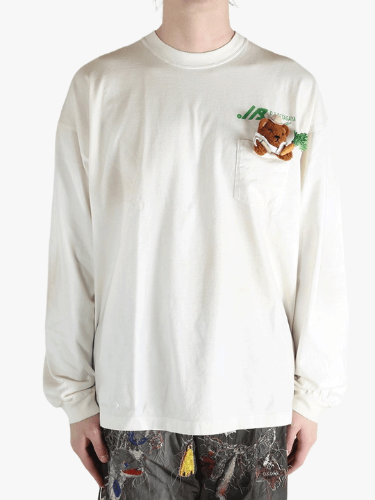 White t-shirt worn by a person, showing the t-shirt's fit