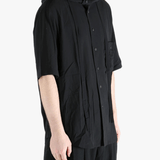 Black shirt worn by a person, showing the shirt's fit