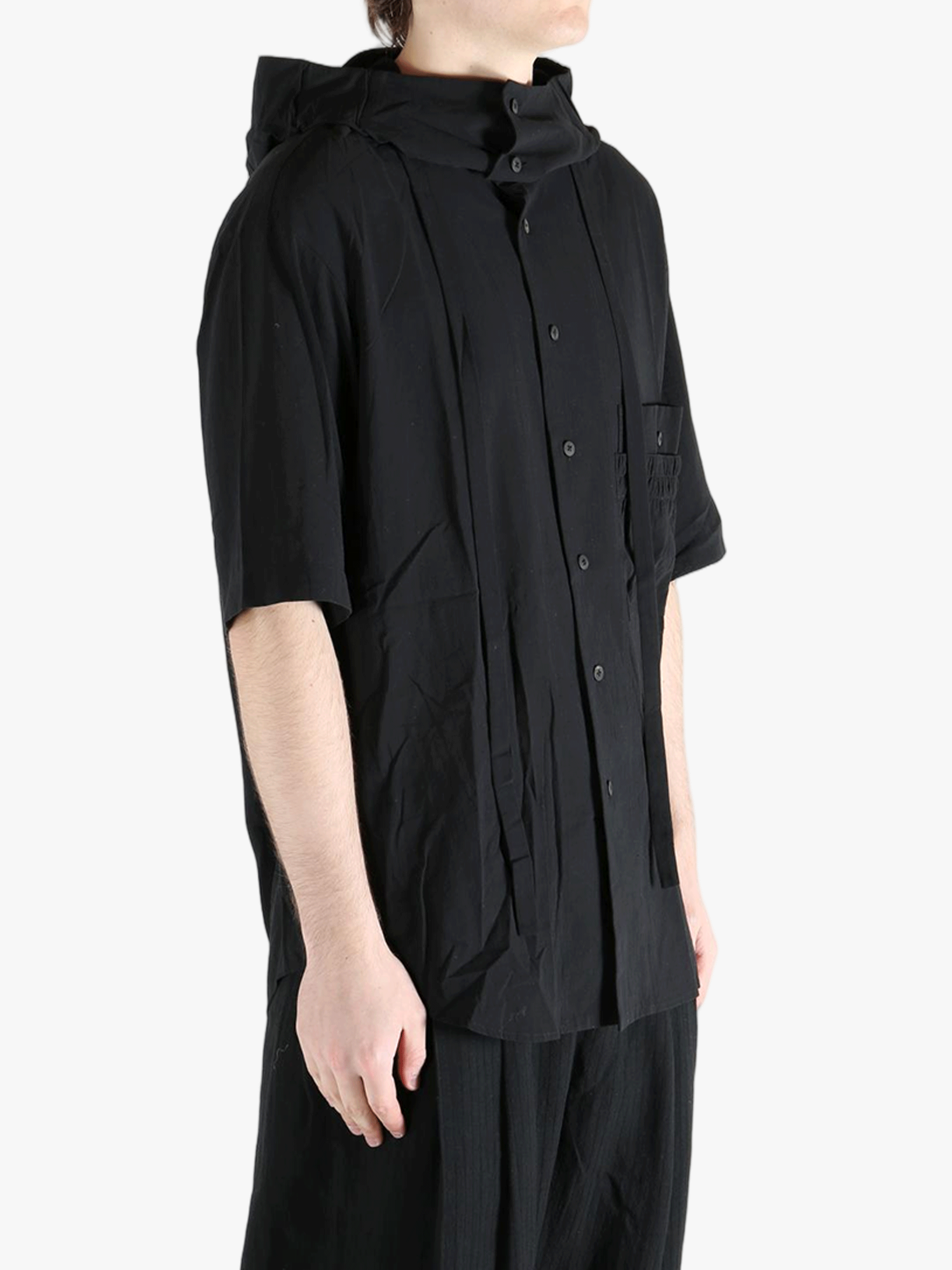 Black shirt worn by a person, showing the shirt's fit