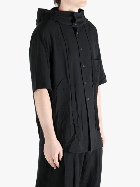 Black shirt worn by a person, showing the shirt's fit