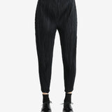 Black pants worn by a person, showing the pants' fit