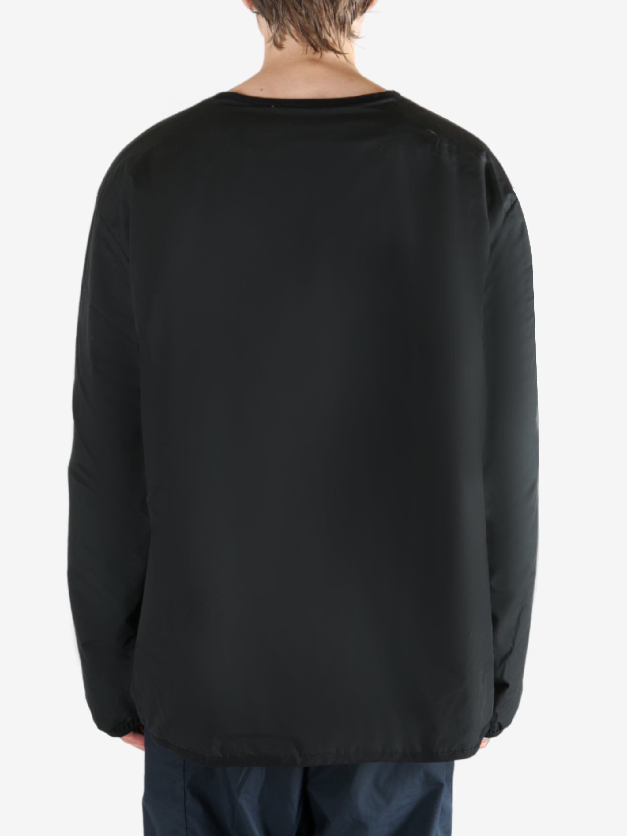 Black cardigan worn by a person, showing the cardigan's fit