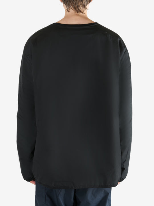 Black cardigan worn by a person, showing the cardigan's fit