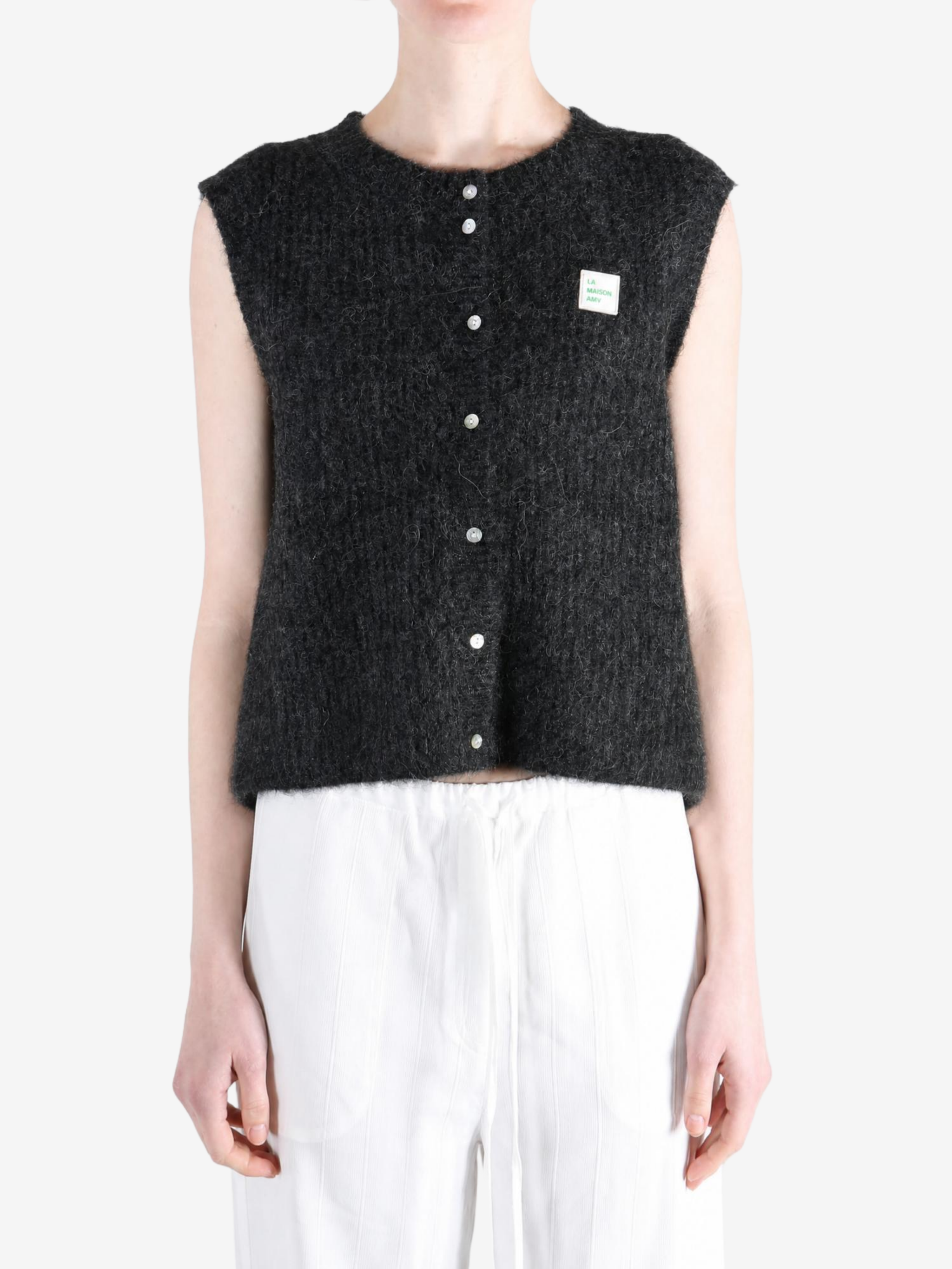 Black knitwear worn by a person, showing the knitwear fit