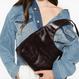 Burgundy bag worn by a person, showing the bag fit
