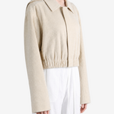 Tan shirt worn by a person, showing the shirt fit