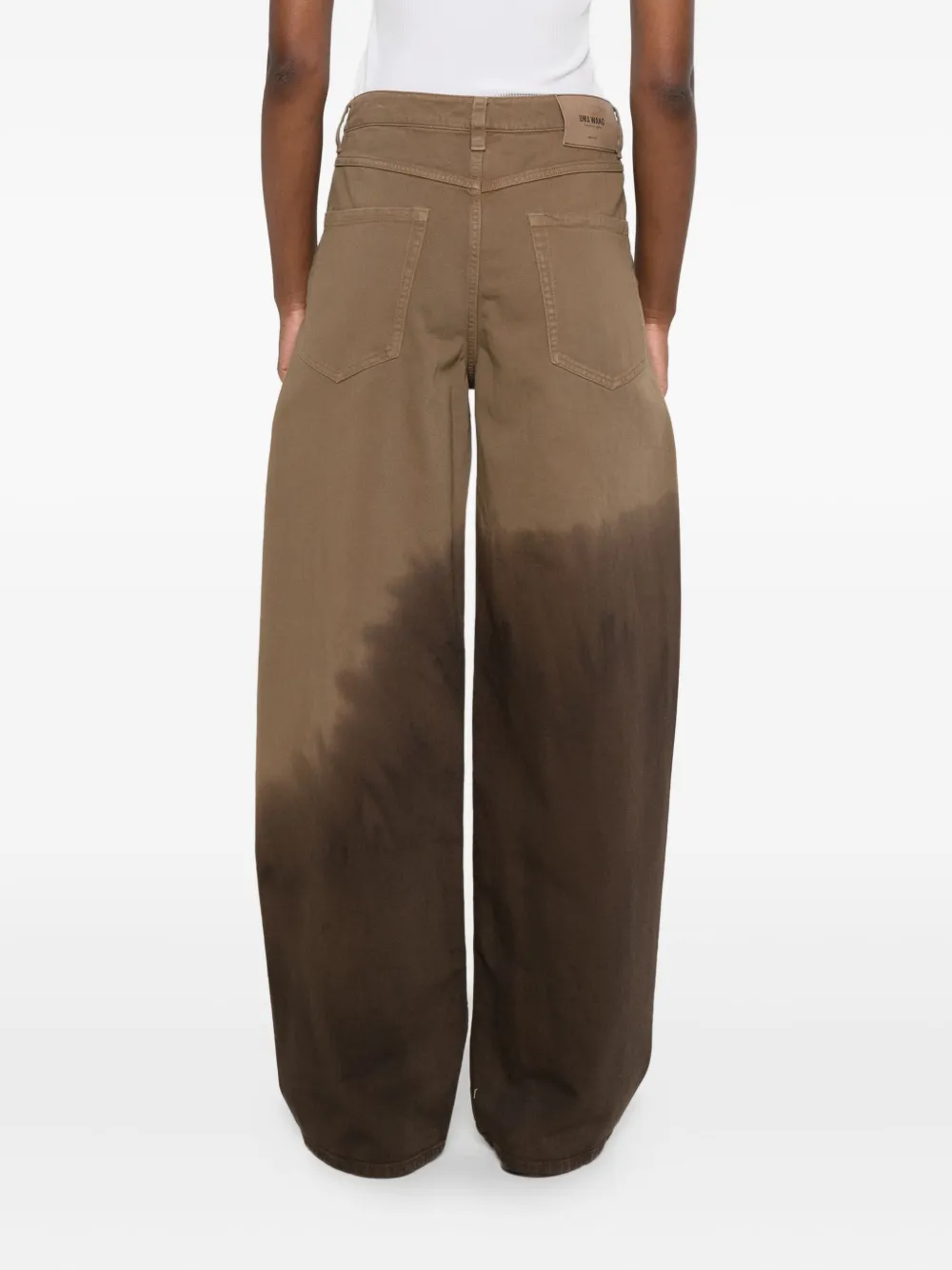 Brown pants worn by a person, showing the pants fit