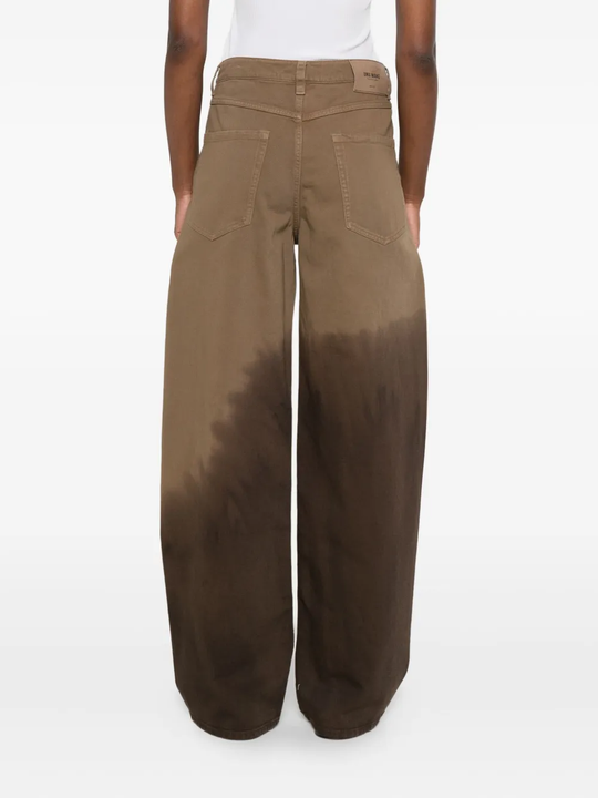 Brown pants worn by a person, showing the pants fit