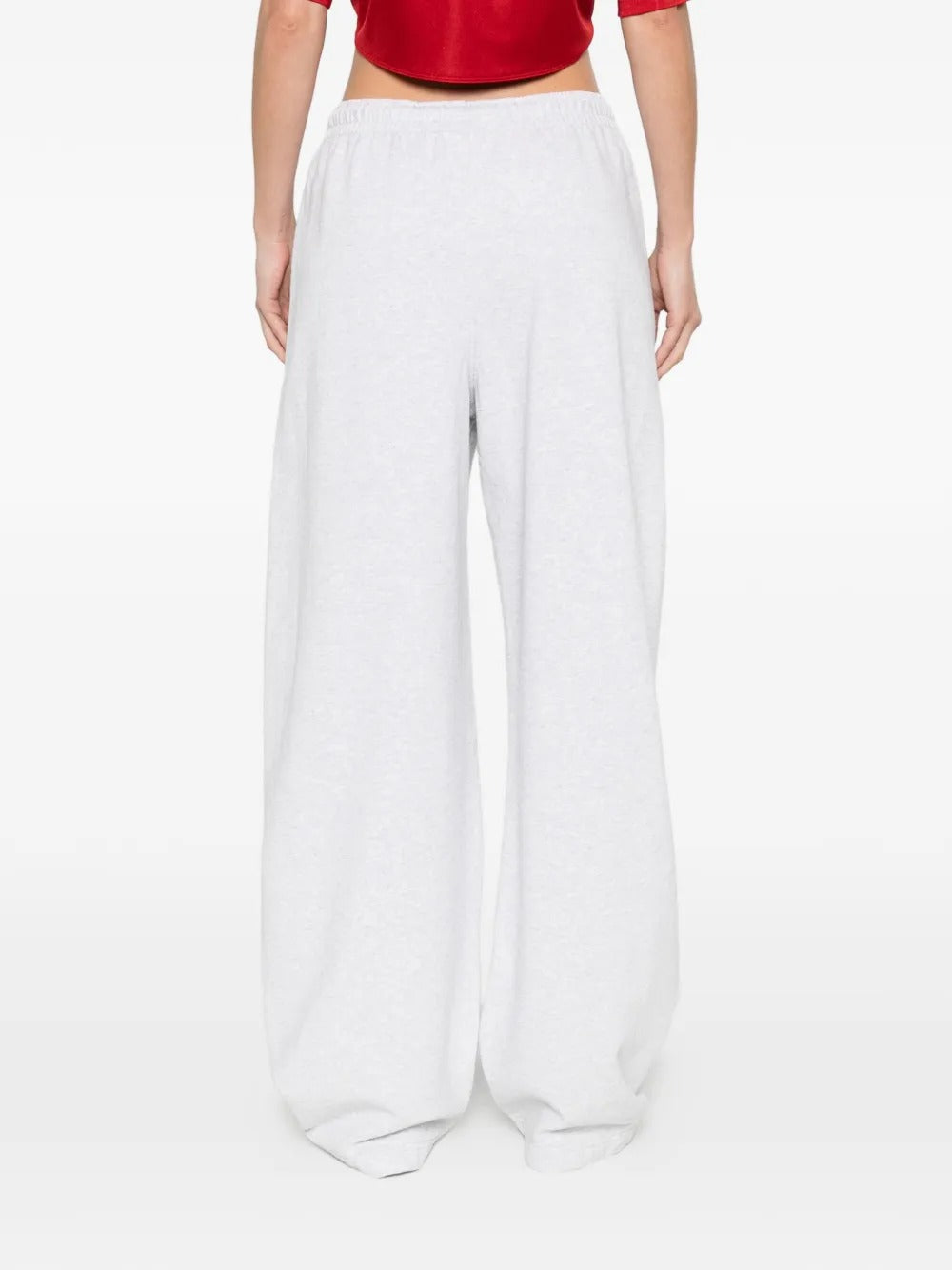 White pants worn by a person, showing the pants' fit