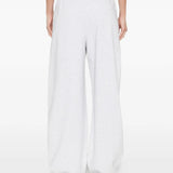 White pants worn by a person, showing the pants' fit