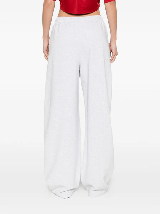 White pants worn by a person, showing the pants' fit