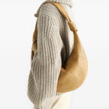Tan bag worn by a person, showing the bag fit