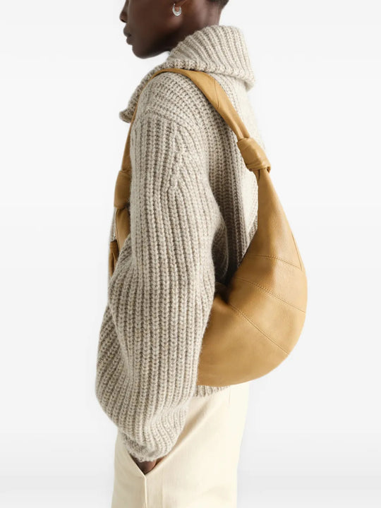 Tan bag worn by a person, showing the bag fit