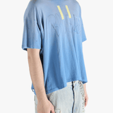 Blue t-shirt worn by a person, showing the shirt's fit