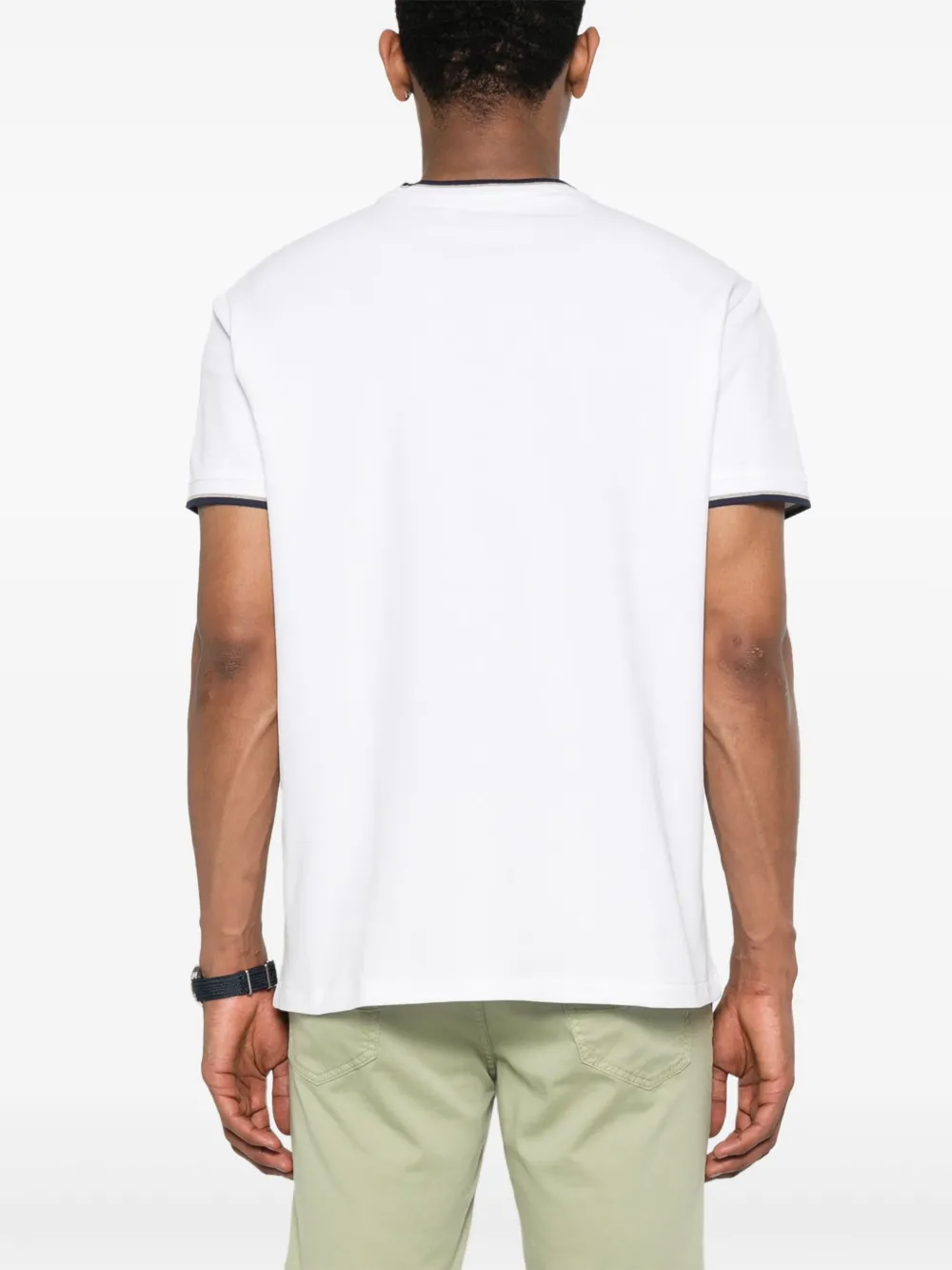 White t-shirt worn by a person, showing the t-shirt fit