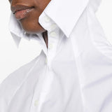 White hoodie worn by a person, showing the hoodie fit