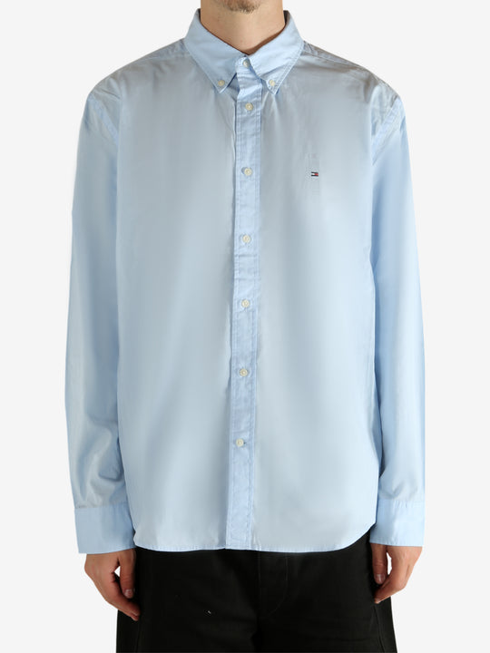 Blue shirt worn by a person, showing the shirt's fit