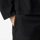 Black pants worn by a person, showing the pants fit