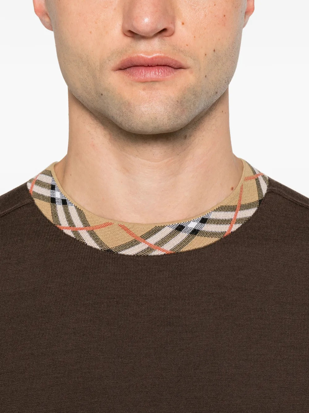 Brown top worn by a person, showing the top fit