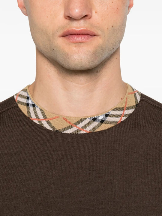 Brown top worn by a person, showing the top fit