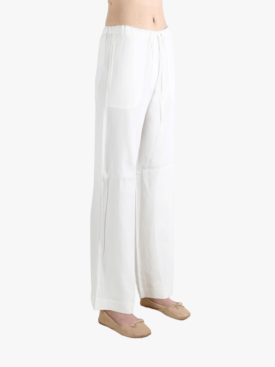 white pants worn by a person, showing the pants  fit