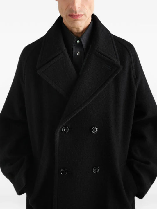 Black jacket worn by a person, showing the jacket fit