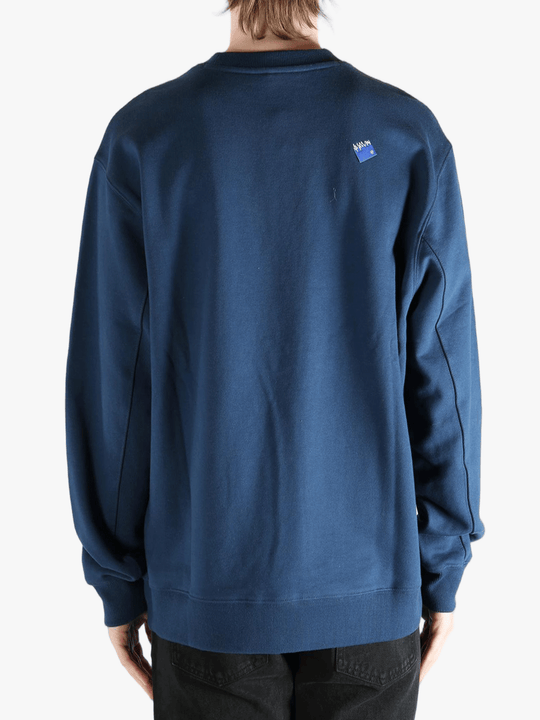 Navy sweater worn by a person, showing the sweater's fit