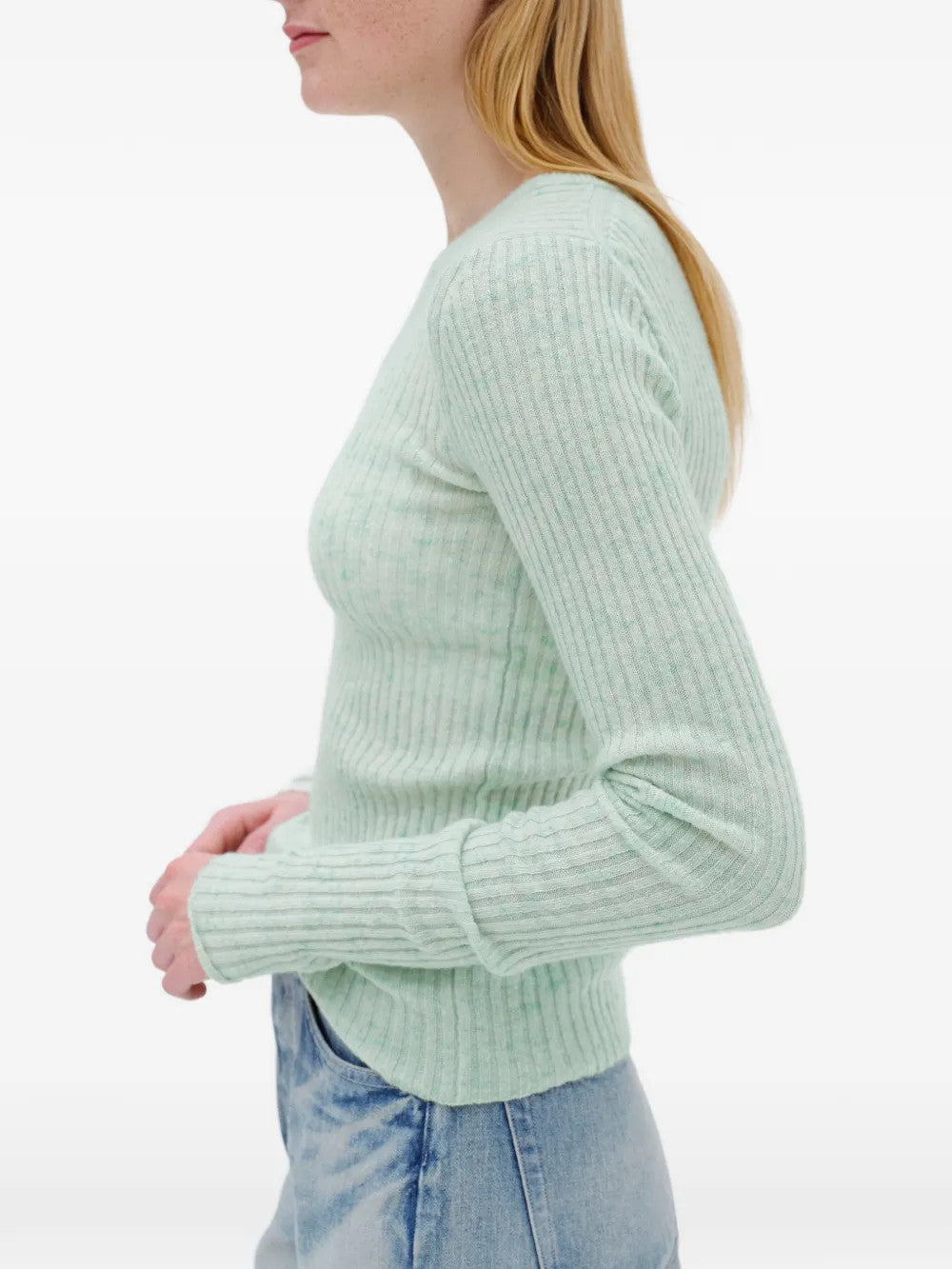 Green knitwear worn by a person, showing the knitwear fit