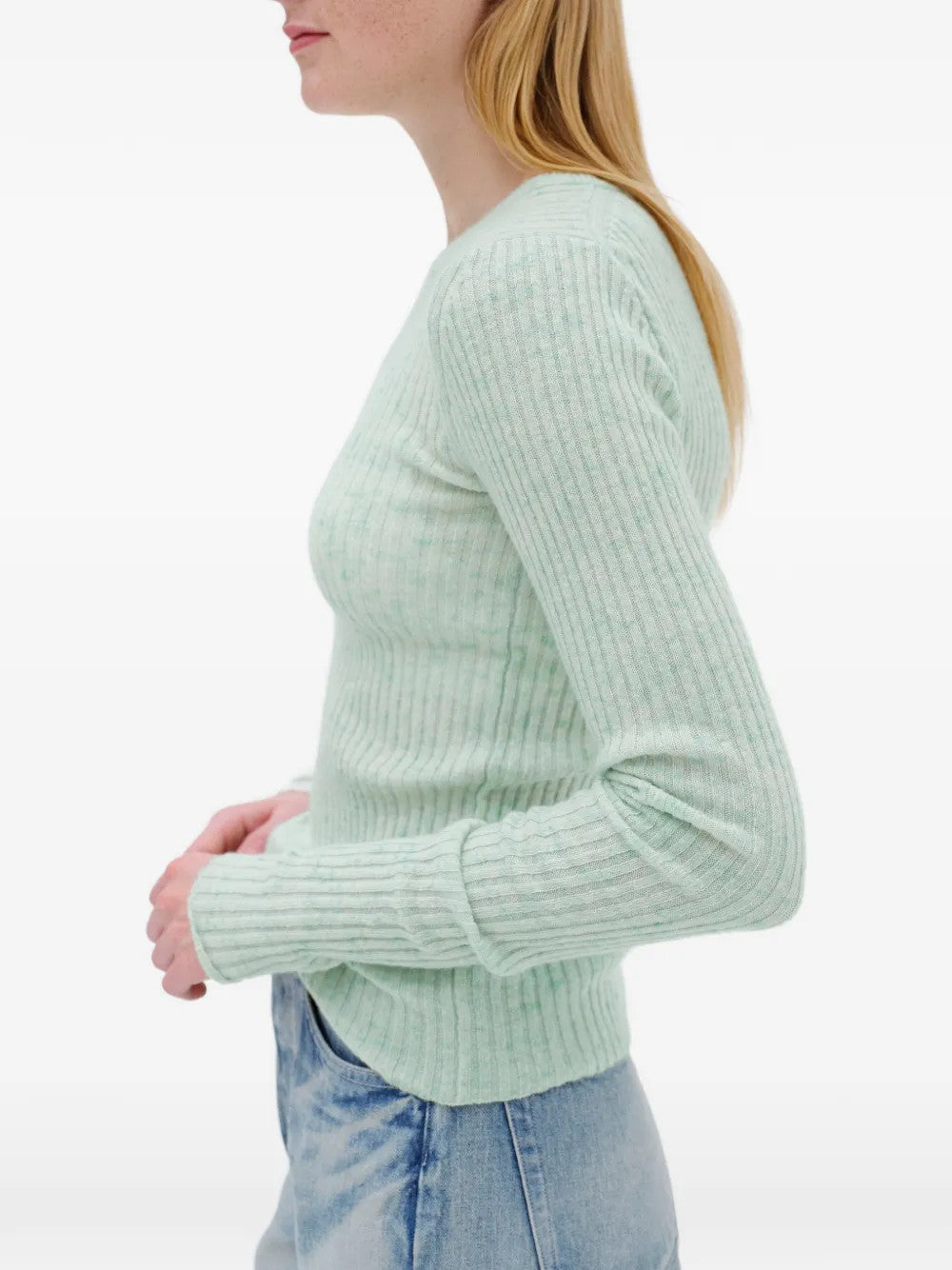 Green knitwear worn by a person, showing the knitwear fit
