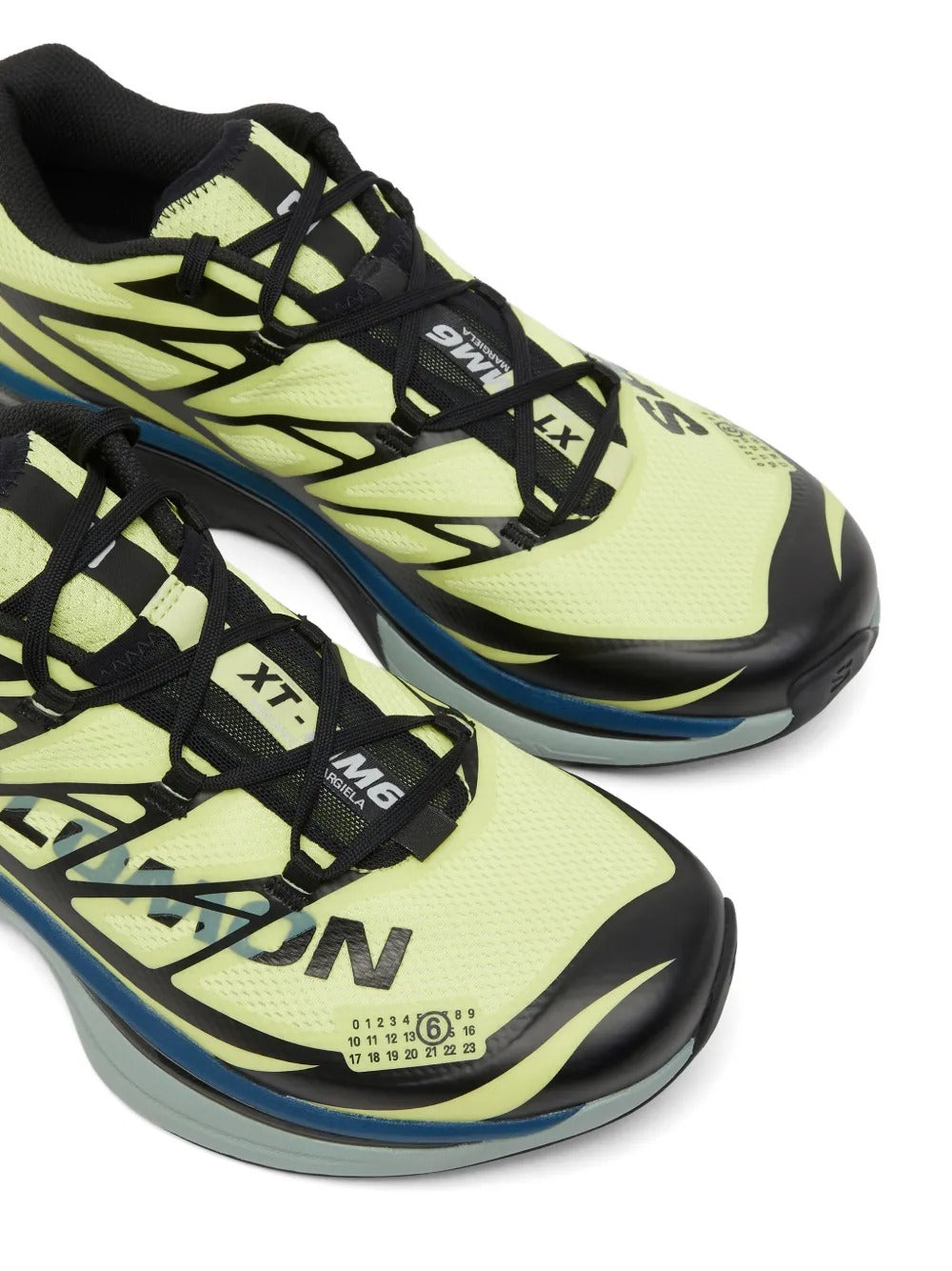 Close up of yellow sneakers, showing texture of the polyester fabric