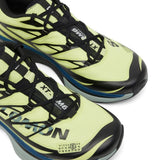 Close up of yellow sneakers, showing texture of the polyester fabric