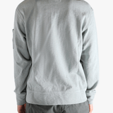 Gray long-sleeve shirt worn by a person, showing the shirt's fit