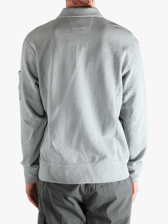 Gray long-sleeve shirt worn by a person, showing the shirt's fit