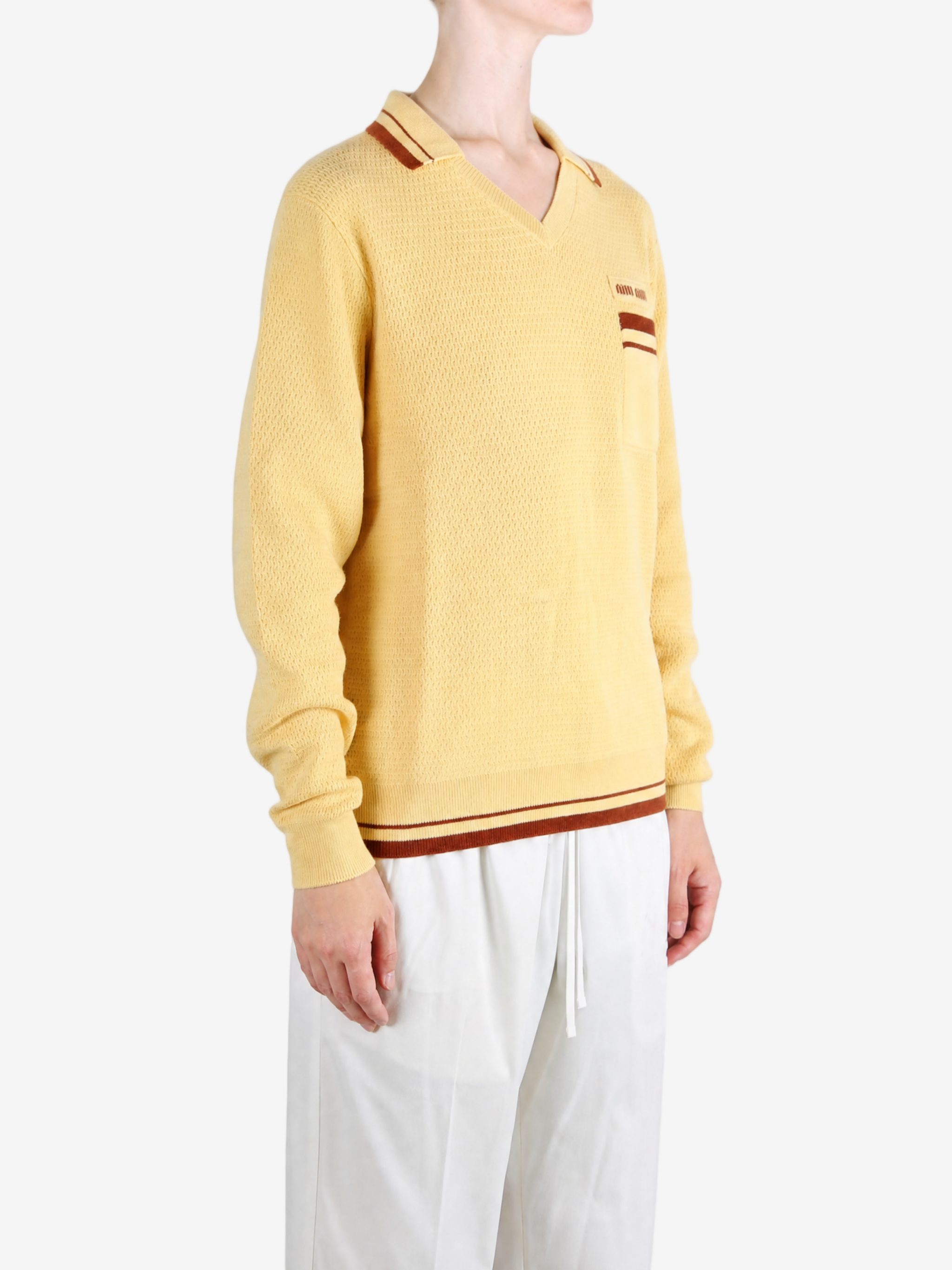 Yellow knitwear worn by a person, showing the knitwear fit