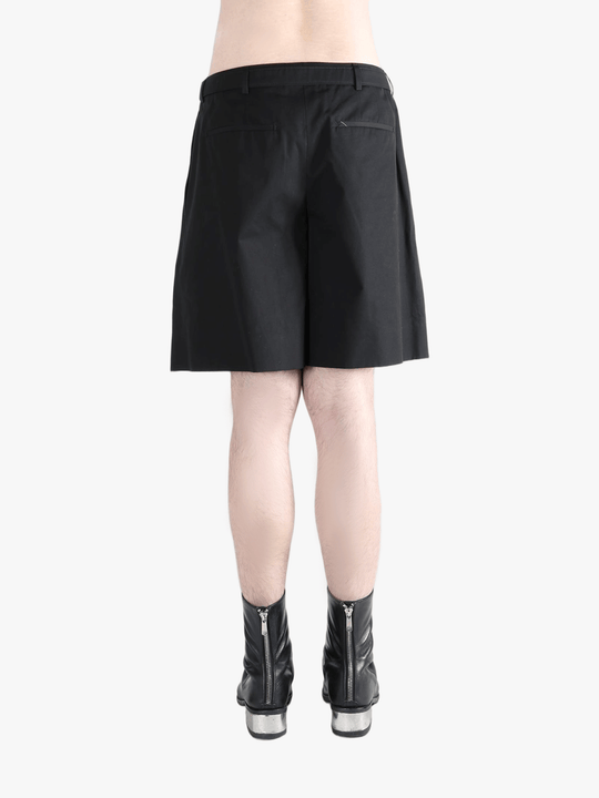 Black short worn by a person, showing the short's fit